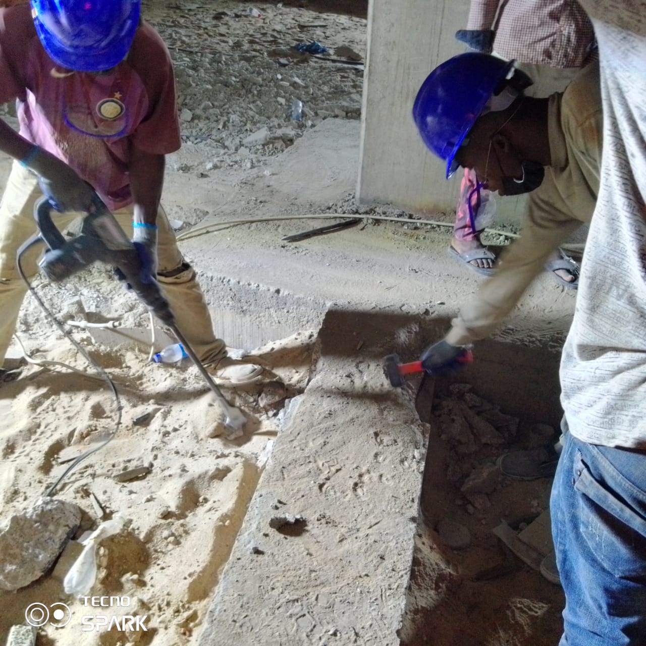 Breaking out deteriorated concrete from the basement floor beam