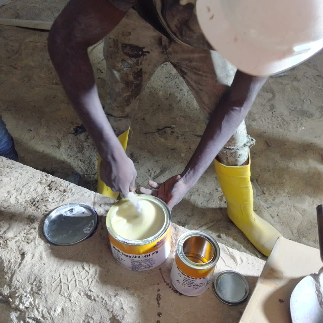 Worker mixing MasterBrace epoxy adhesive components on site
