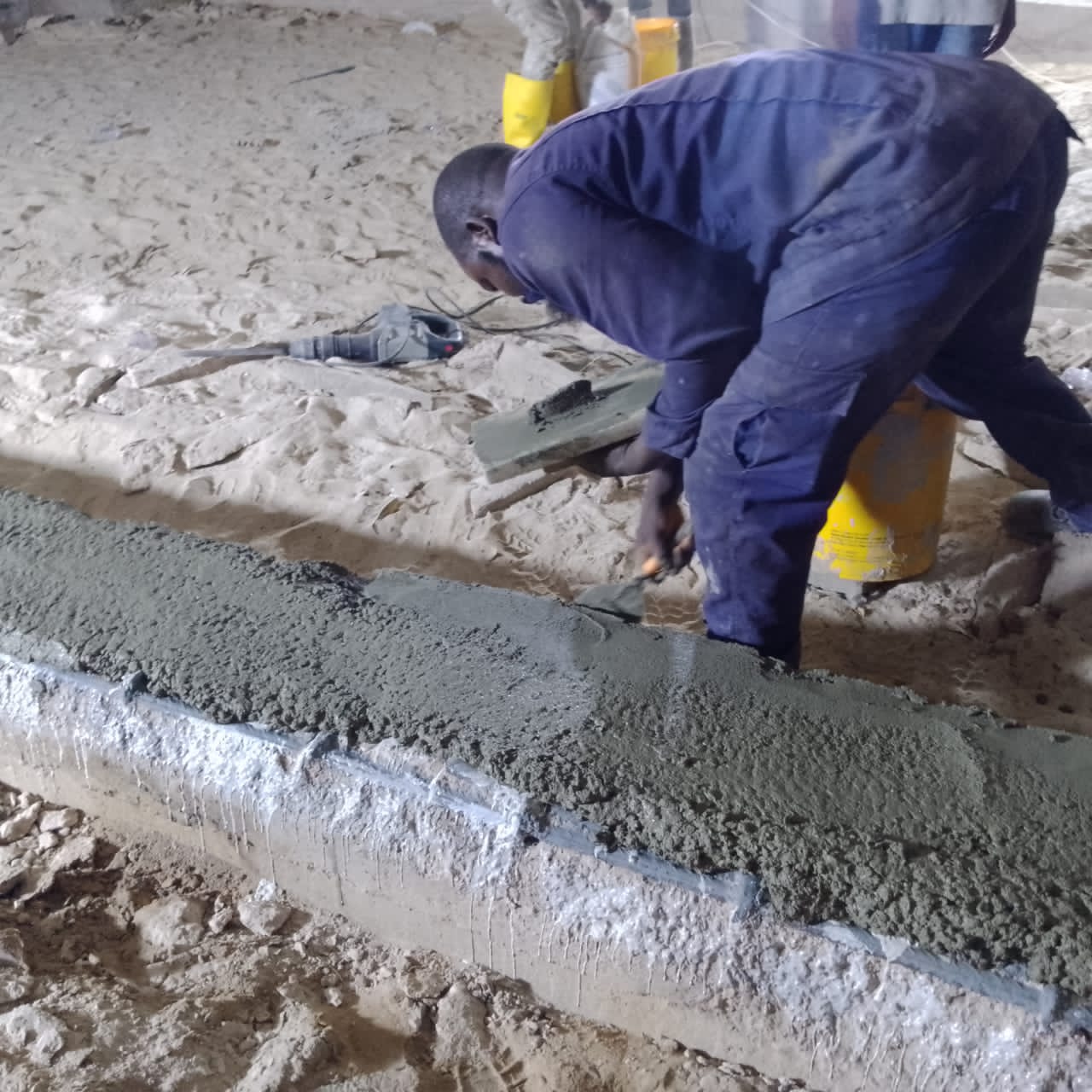 Operative finishing the repair mortar face of a basement beam