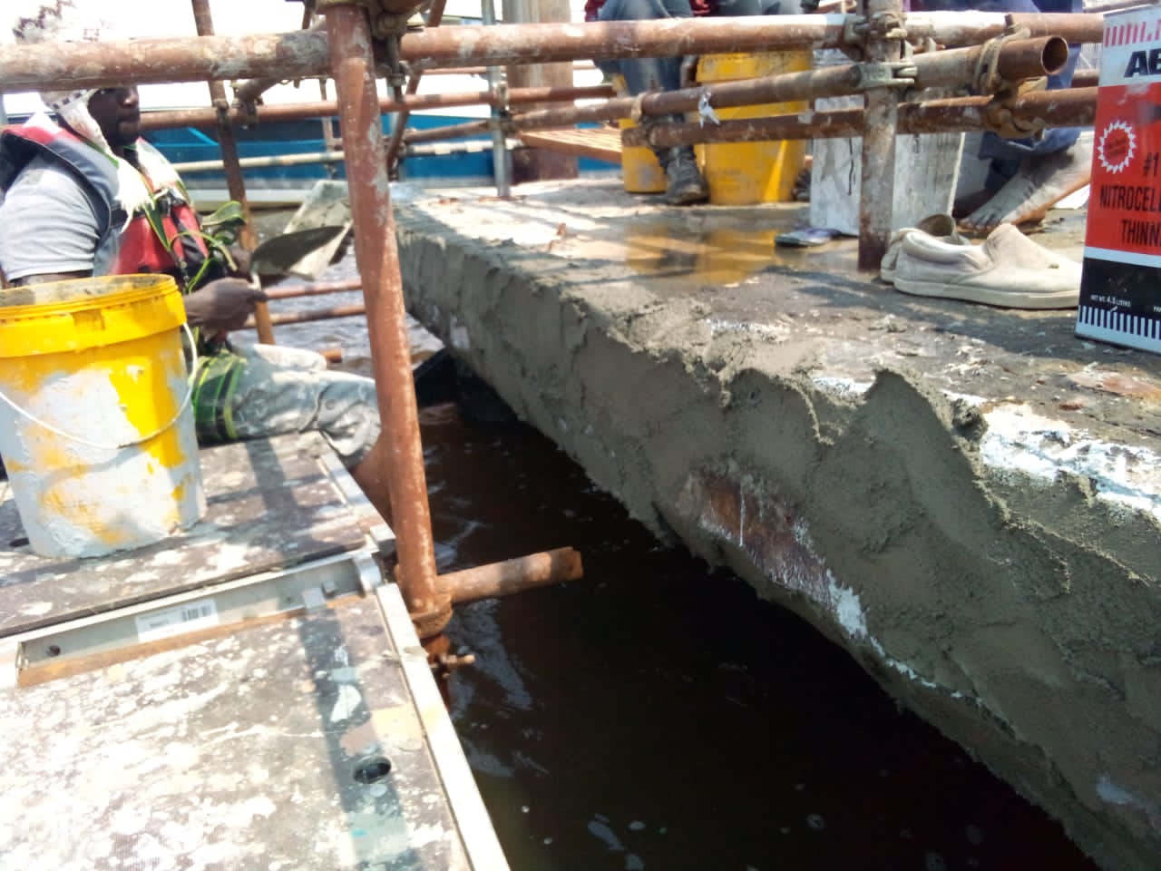 Freshly applied repair mortar along the jetty deck edge