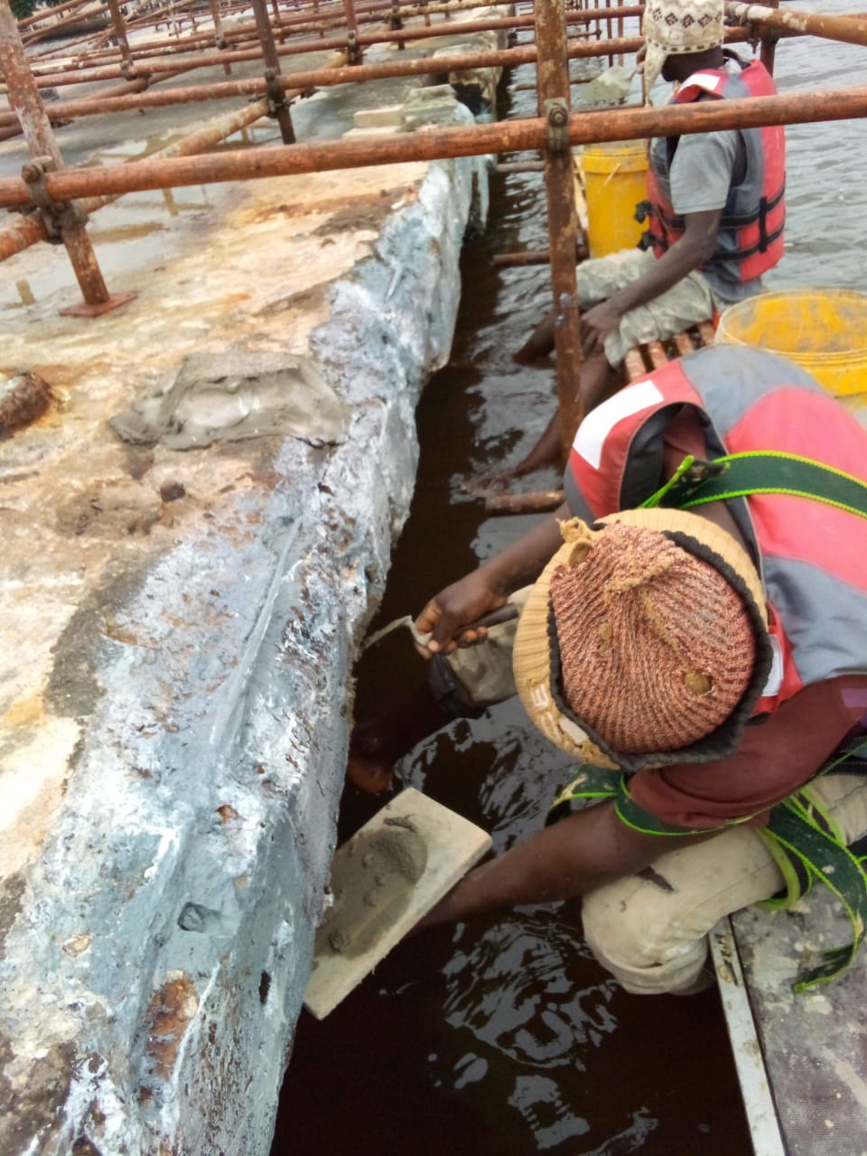 Hand-trowelling repair mortar to the jetty beam face