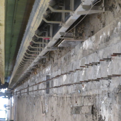 Prepared anchor bolt line ready for grouting beside the conveyor