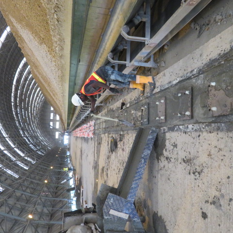 Site engineer setting out the rail line beside the conveyor
