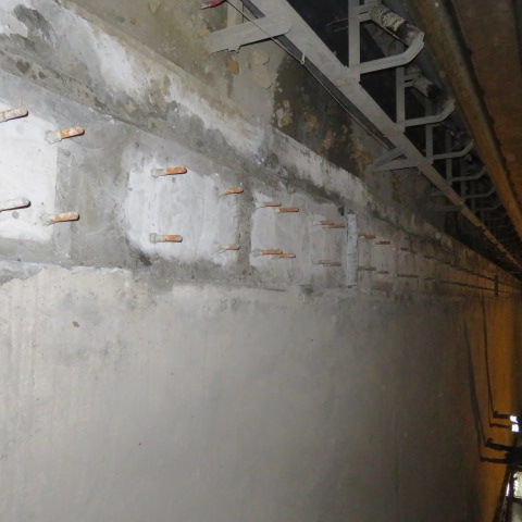 Grouted rail pedestals with protruding anchor bolts along the trench
