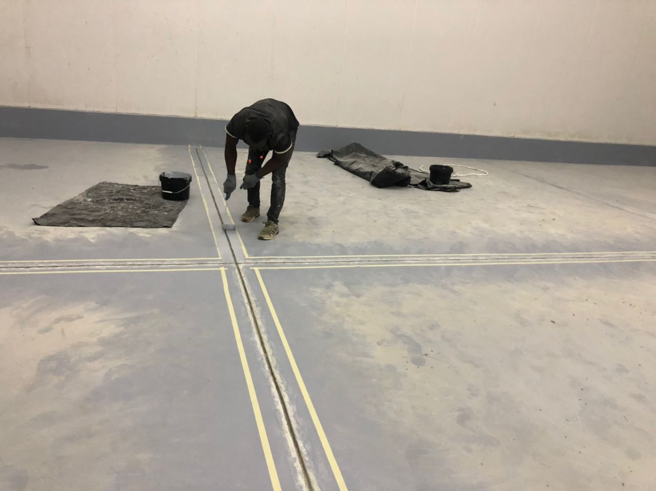 Roller application of joint coating along the marked line