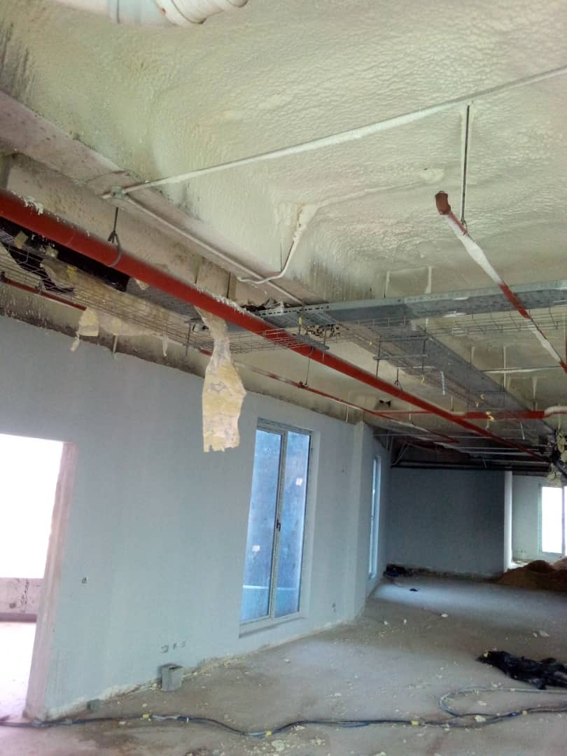 Insulated soffit and sprinkler pipework across a finished floor